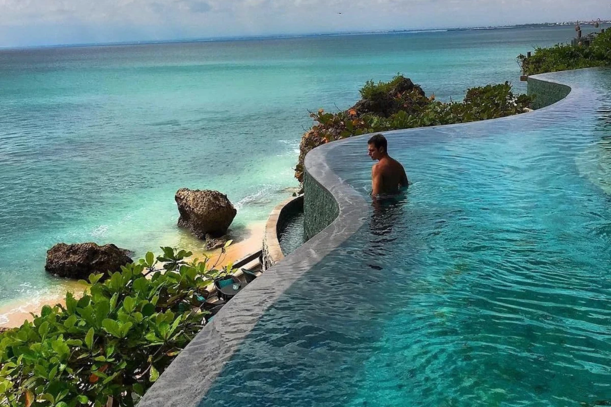 person in infinity pool in bali